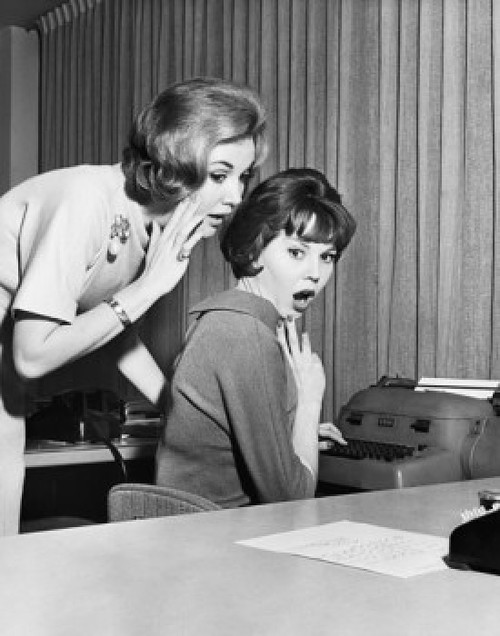 Side profile of a businesswoman whispering to another businesswoman in an office Poster Print - Item # VARSAL25527684
