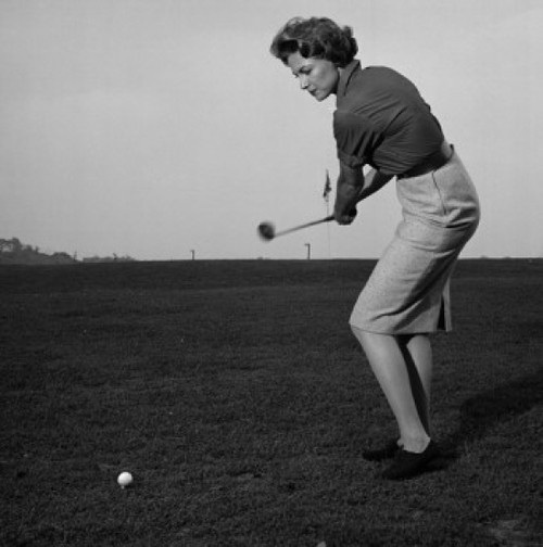 Mid adult woman swinging a golf club on a golf course Poster Print - Item # VARSAL2558894