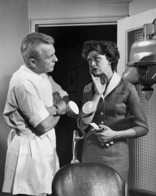 Female patient suffering from toothache standing with dentist Poster Print - Item # VARSAL255489
