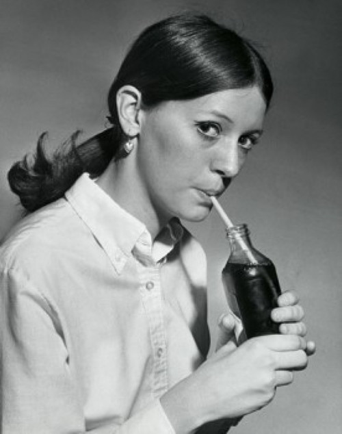 Portrait of a young woman drinking out of a bottle with a drinking straw Poster Print - Item # VARSAL25512641