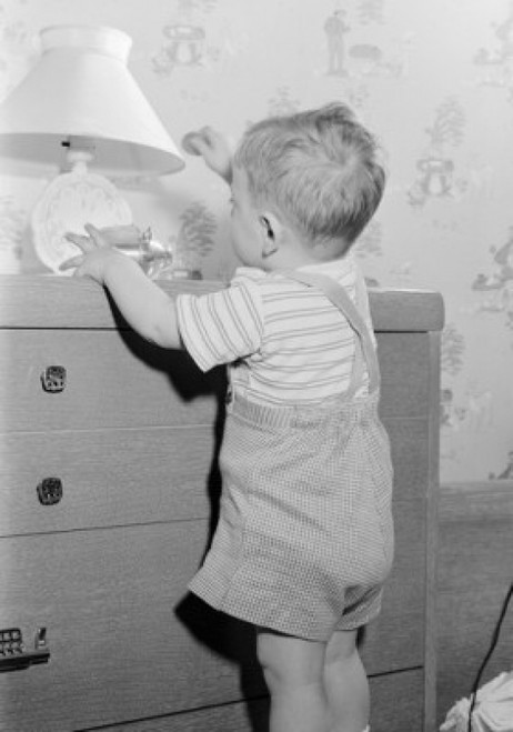 Boy playing on drawer chest Poster Print - Item # VARSAL255416983