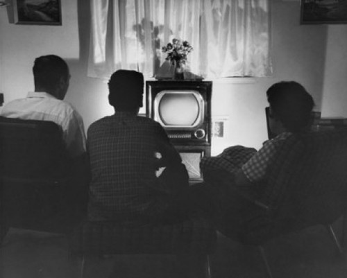 Rear view of parents with their son sitting in front of a television Poster Print - Item # VARSAL2551609