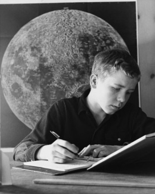 Teenage boy writing in a spiral notebook Poster Print - Item # VARSAL25517581