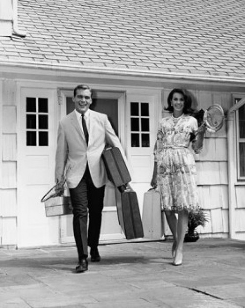 Mid adult couple walking with luggage for vacation Poster Print - Item # VARSAL25525540