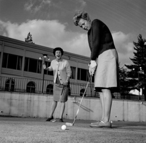 Excited woman watching while other is playing golf Poster Print - Item # VARSAL255417761