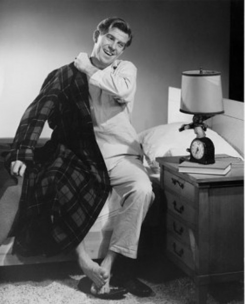 Mid adult man sitting on bed smiling Poster Print - Item # VARSAL2554728