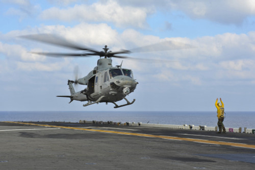 South China Sea, February 7, 2013 - Aviation Boatswain's Mate directs a UH-1Y Venom helicopter as it lifts off from the amphibious assault ship USS Bonhomme Richard Poster Print - Item # VARPSTSTK106788M