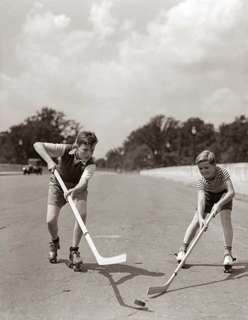 1930s-1940s 2 Boys With Sticks And Puck Wearing Roller Skates Playing Street Hockey Print By Vintage Collection - Item # PPI177114LARGE