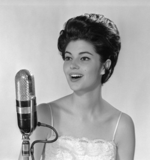 Young woman singing into microphone Poster Print - Item # VARSAL255417884