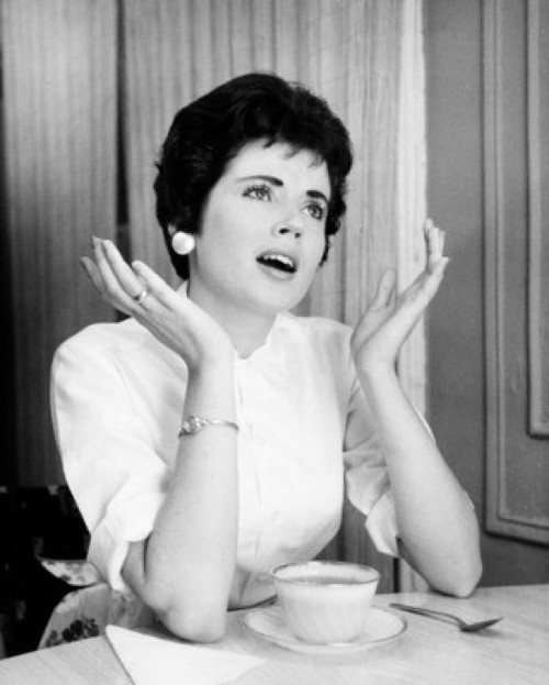 Young woman sitting with a tea cup gesturing Poster Print - Item # VARSAL25512655