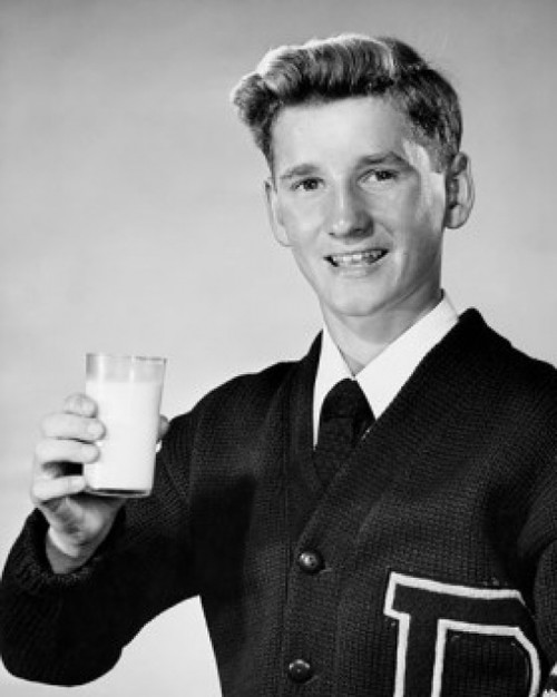 Portrait of a teenage boy holding a glass of milk Poster Print - Item # VARSAL25512688
