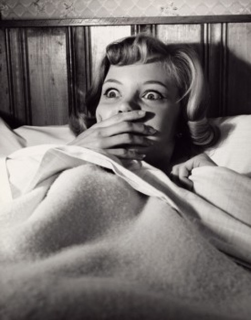 Close-up of a young woman lying in bed looking frightened Poster Print - Item # VARSAL2552875