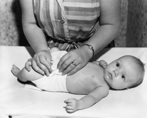 Mid section view of a woman changing her baby's diaper Poster Print - Item # VARSAL2559300