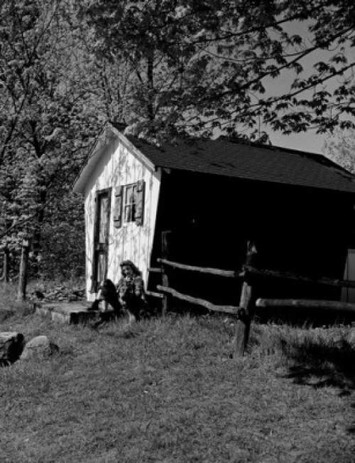Young woman sitting outside shed Poster Print - Item # VARSAL255416896