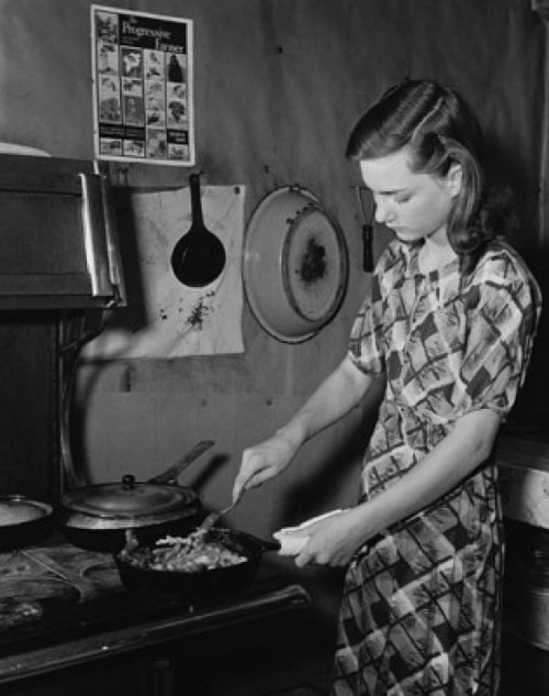 Young woman cooking food in the kitchen Poster Print - Item # VARSAL9901965