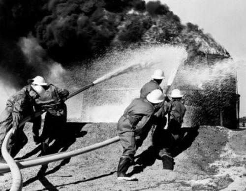 Firemen fighting oil fire Poster Print - Item # VARSAL255424592