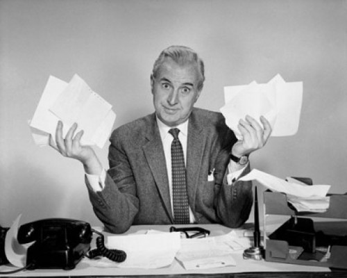 Businessman sitting at a desk and holding documents Poster Print - Item # VARSAL2552740