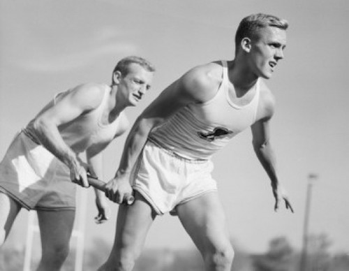 Two men running on relay Poster Print