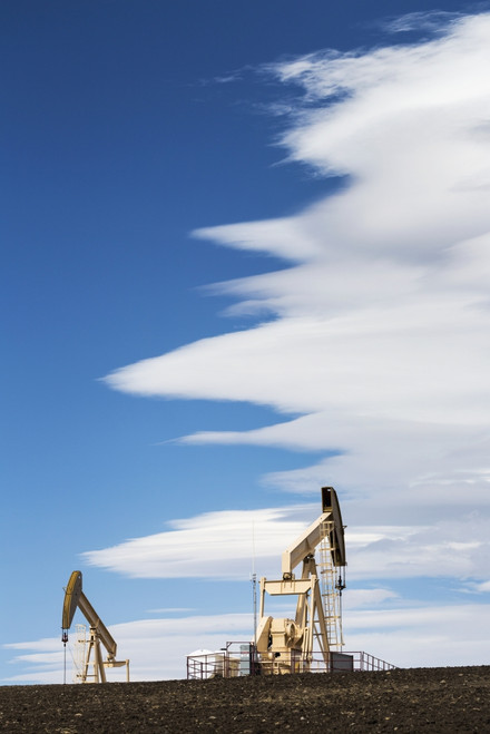 Two pumpjacks on a hill with dramatic clouds in the blue sky; Alberta, Canada PosterPrint - Item # VARDPI12277135