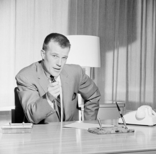Portrait of businessman sitting behind desk in office Poster Print - Item # VARSAL255422429