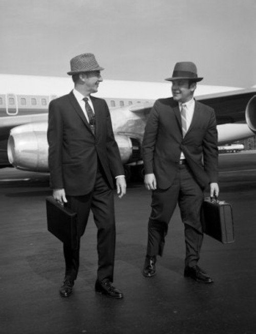 Two men walking along airplane at airport Poster Print - Item # VARSAL255416289