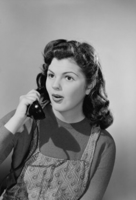 Studio portrait of young woman using telephone Poster Print - Item # VARSAL255422991B