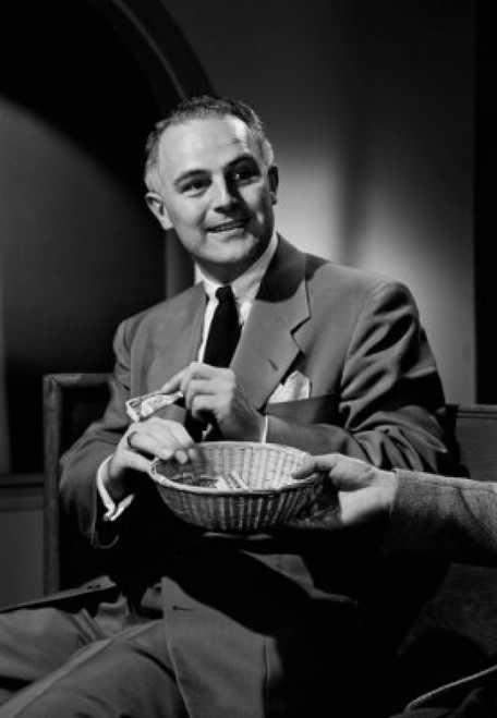 Man putting money into collection basket Poster Print - Item # VARSAL255417516