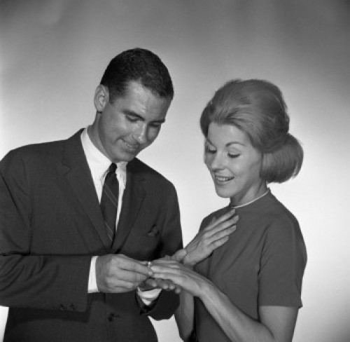 Man putting ring on woman's palm  studio shot Poster Print - Item # VARSAL255417384