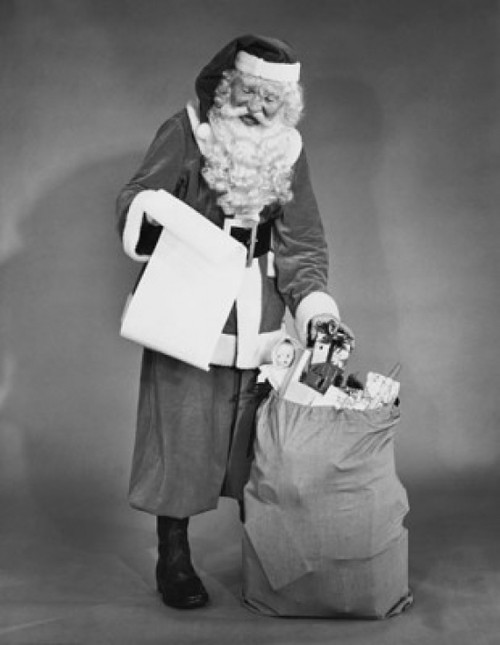 Santa Claus standing near a sack of gifts and checking a list of names Poster Print - Item # VARSAL255325 Santa Claus standing near a sack of gifts and checking a list of names Poster Print - Item # VARSAL255325