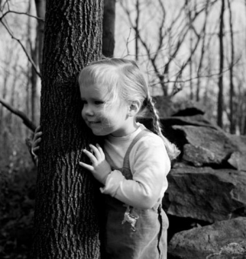 Cute girl  with braids embracing tree Poster Print - Item # VARSAL255416457