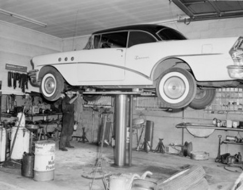 Man repairing car lifted up in garage Poster Print - Item # VARSAL255421669