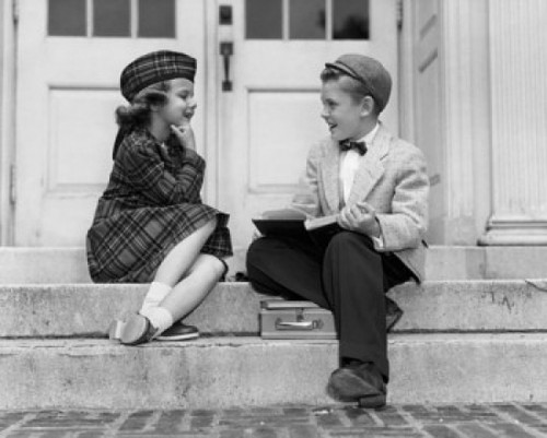 Schoolboy and a schoolgirl sitting and looking at each other Poster Print - Item # VARSAL25518071C