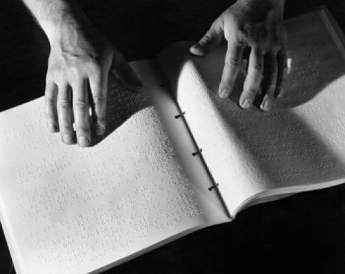 High angle view of a person's hand reading Braille Poster Print - Item # VARSAL25527814