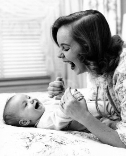 Young woman playing with baby on bed Poster Print - Item # VARSAL2559868B