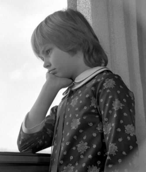 Pensive boy looking through window Poster Print - Item # VARSAL25514406