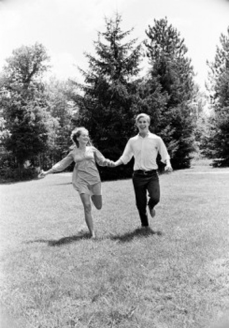 Young couple running in forest Poster Print - Item # VARSAL255416487