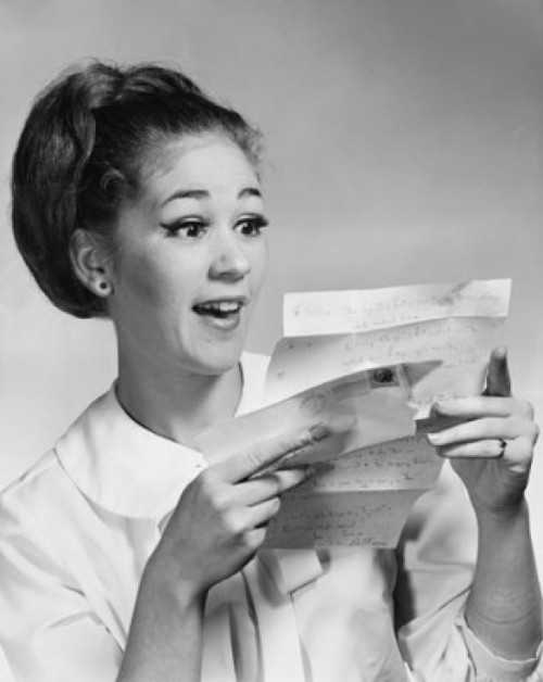 Close-up of a young woman reading a letter Poster Print - Item # VARSAL25527207B