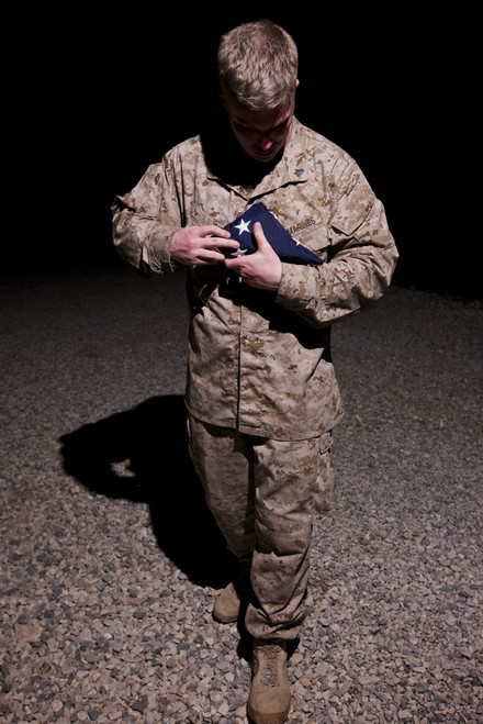 U.S. Marine holding the American Flag Poster Print