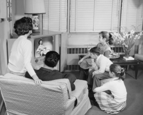 Rear view of parents with their three children watching television Poster Print - Item # VARSAL2551608