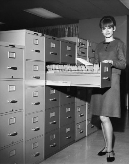 Portrait of a businesswoman standing beside a filing cabinet Poster Print - Item # VARSAL25548499
