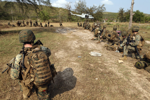 U.S. Marines provide security as a UH-1N Huey helicopter takes off from Thailand Poster Print - Item # VARPSTSTK104113M