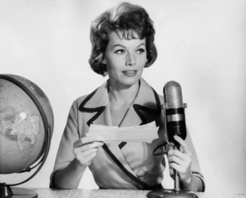 Mid adult woman reading a report on a microphone Poster Print - Item # VARSAL2557807A