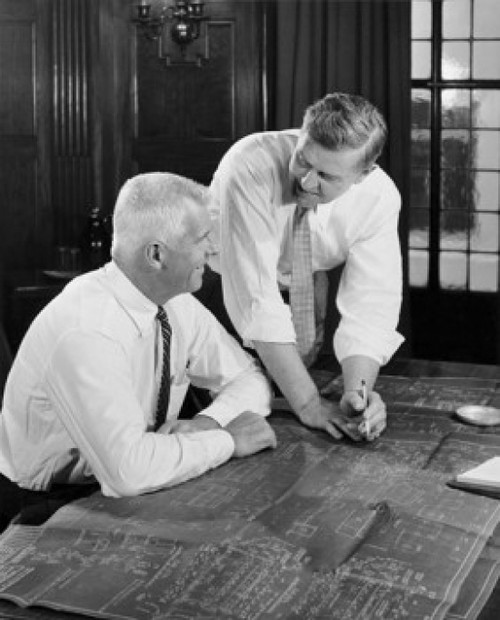 Two businessmen discussing blueprint in office Poster Print - Item # VARSAL25547976