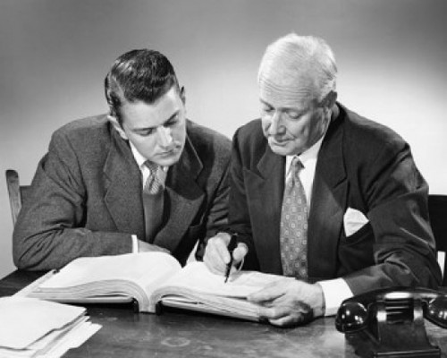 Two businessmen reading a book Poster Print - Item # VARSAL2552745