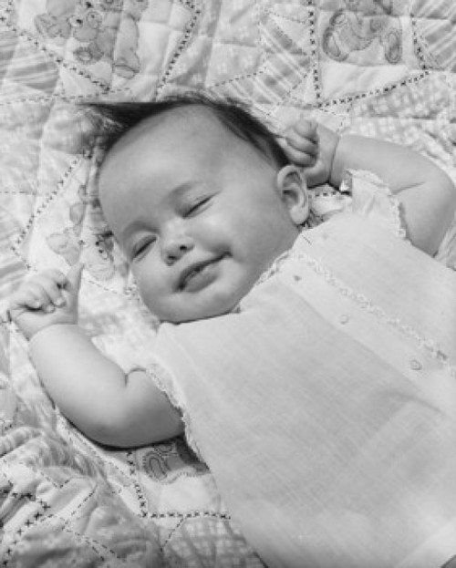 High angle view of a baby girl smiling and sleeping Poster Print - Item # VARSAL2559642B