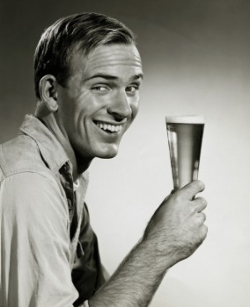 Portrait of a young man holding a glass of beer Poster Print - Item # VARSAL2553021