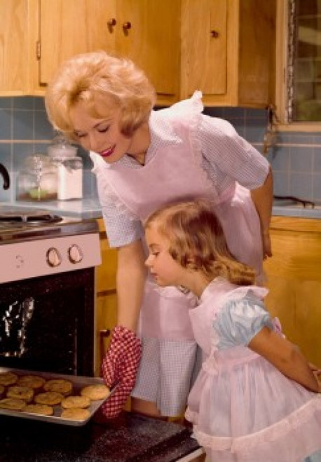 Mid adult woman putting cookies in an oven with her daughter standing beside her Poster Print - Item # VARSAL9592583