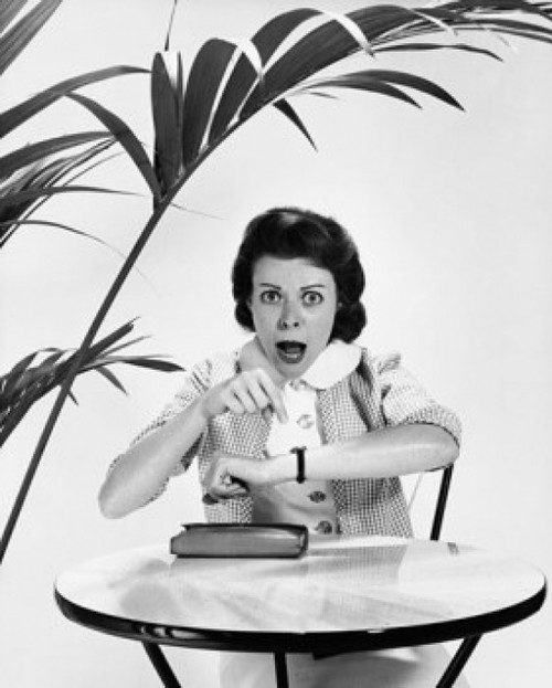 Mid adult woman pointing to her wristwatch and looking angry Poster Print - Item # VARSAL2552390B