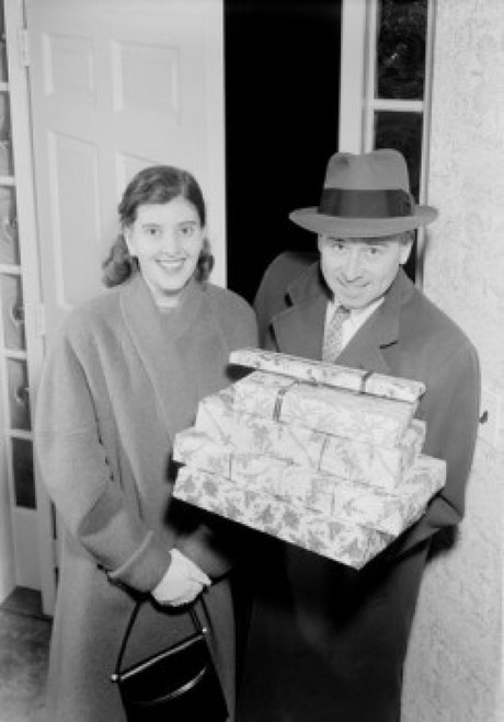 Couple carrying Christmas presents in doorway Poster Print - Item # VARSAL255422275