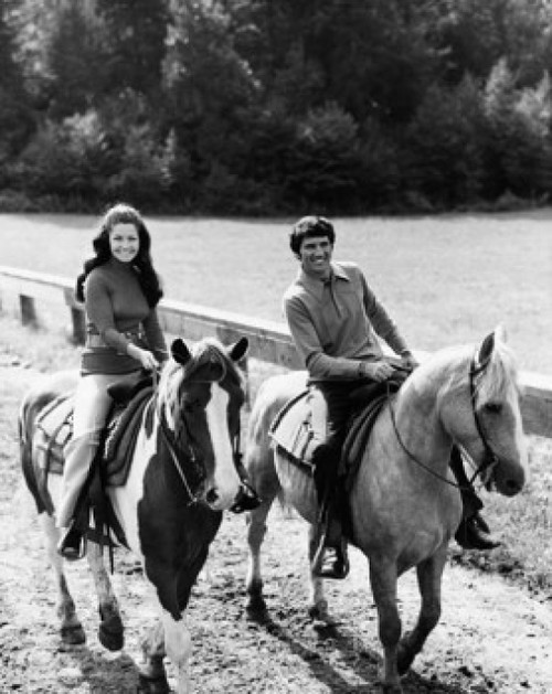 Young couple riding horses in a field Poster Print - Item # VARSAL25541383